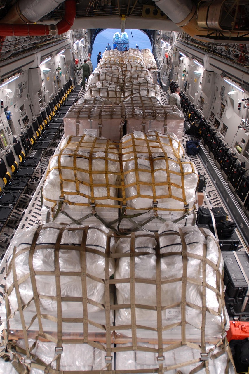 aircraft, plane, cargo, hold, bundles, crates, packages, body, military, lights, brown plane, brown body, brown airplane, aircraft, cargo, cargo, cargo, cargo, cargo, crates, crates, crates, packages